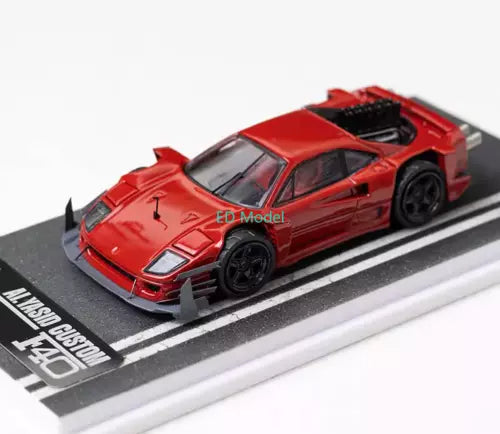 Red 1:64 diecast racing sports car model with black wheels, on display base.