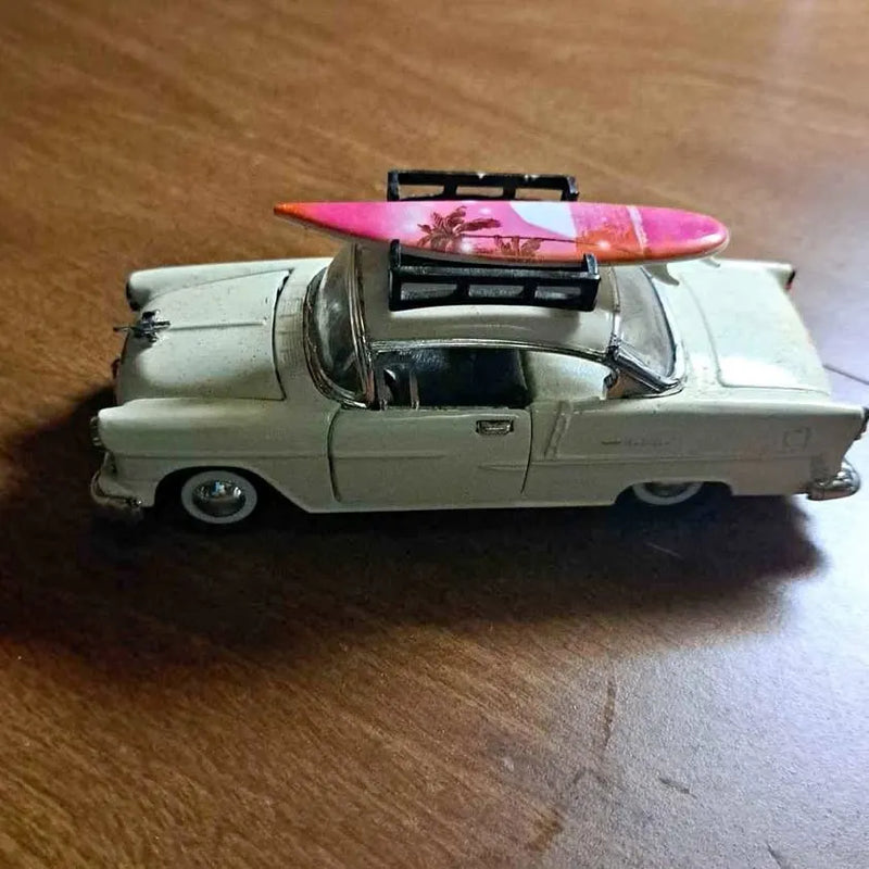 Light green diecast classic car with open hood and pink engine cover