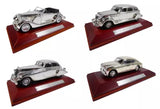 Set of four 1:43 silver diecast classic cars on display bases