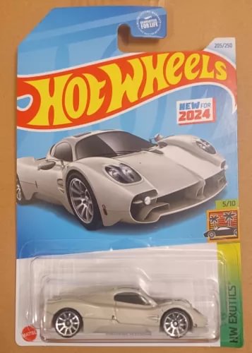 Hot Wheels diecast sports car in blister pack, light gray with black details