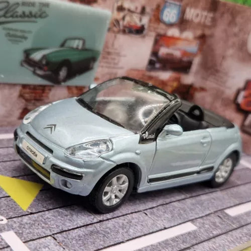 Diecast model car, light blue convertible with open cabin, front three-quarter view
