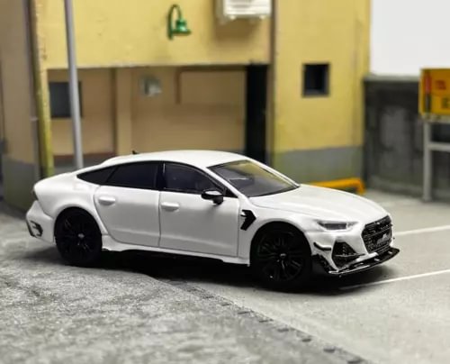 White racing diecast sports sedan model car with black wheels, front 3/4 view