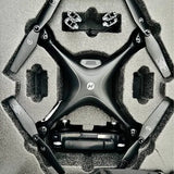 Black FPV drone with GPS, top view, four arms and prop guards