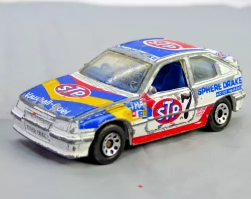 Racing diecast toy car in blue and white with red stripe, front 3/4 view