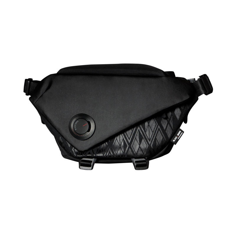 Black camera sling bag with front circular logo patch and adjustable straps