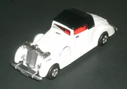 Vintage white diecast roadster model car with black hood and red grille details