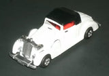 Vintage white diecast roadster model car with black hood and red grille details