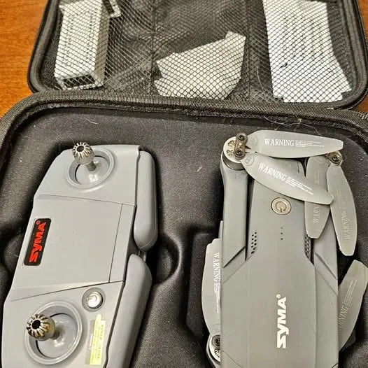 Syma quadcopter drone and controller in black hard case, white body
