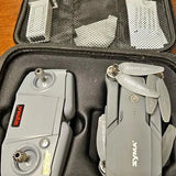 Syma quadcopter drone and controller in black hard case, white body