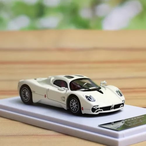 Beige 1/64 scale diecast sports car model on display stand