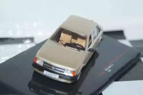 Beige diecast car model, front view with chrome grille, 1:43 scale