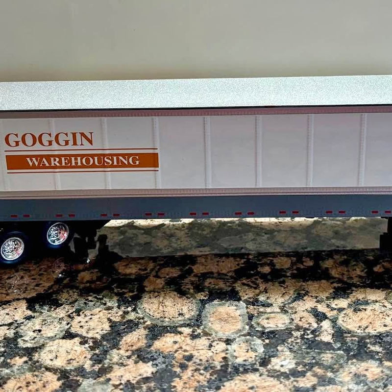 Diecast tractor-trailer model with blue and white trailer, GOGGIN warehousing text