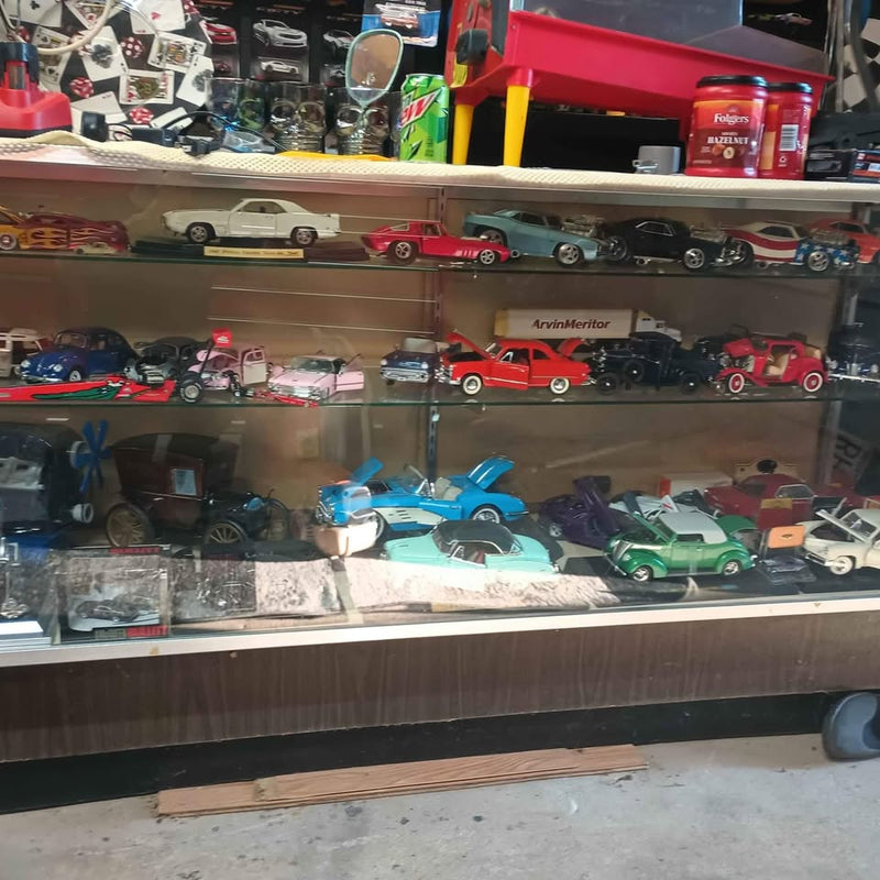 Diecast car display case with glass front and multiple diecast cars on shelves