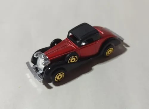Red and black diecast coupe roadster toy car with open hood and details