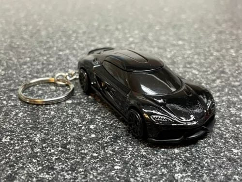 Black diecast car keychain with keyring, front three-quarter view