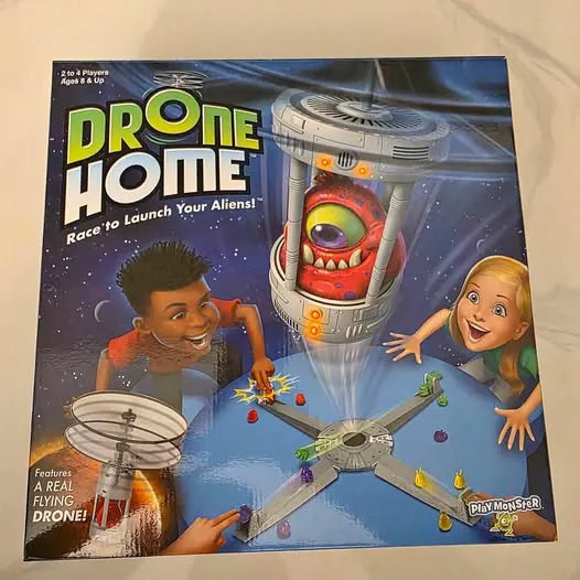 Drone Home board game box with cartoon alien spaceship and two kids