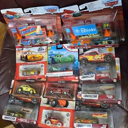 Assorted diecast toy cars in original blister boxes, multiple colors and designs