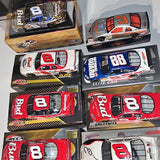 NASCAR diecast race cars, red and blue models in boxed packaging