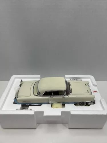 Diecast 1956 Packard Caribbean hardtop model car, cream with black roof