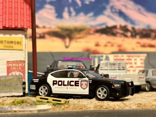 Police muscle model diecast car with black body and white doors, front 3/4 view