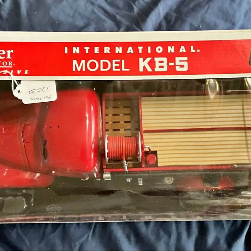 Red diecast firetruck model KB-5 with open side cab and equipment detail