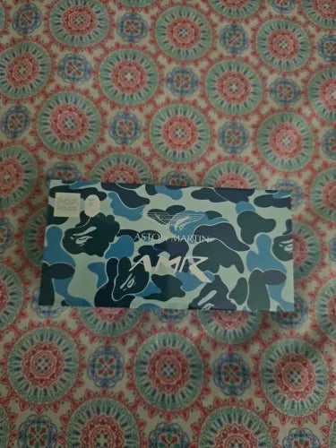 Aston Martin GT3 diecast toy card with blue camo print and logos
