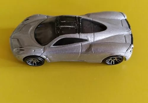 Silver diecast super car model with black interior and detailed wheels