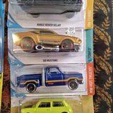 Diecast car set with three vehicles: green car, blue pickup, and yellow Mustang.