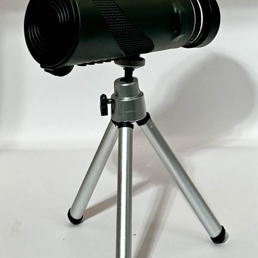 Monocular telescope with green lens housing and silver tripod stand