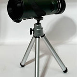 Monocular telescope with green lens housing and silver tripod stand
