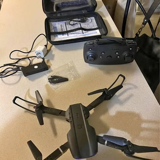 Foldable quadcopter drone with black hard case and controller