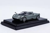 Grey diecast sports car model with detailed wheels on black display base