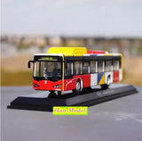 Red and black diecast bus model with yellow roof on display base