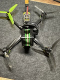 iFlight Nazgul5 V2 FPV drone, black frame with green propellers and camera mount