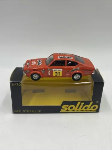Diecast rally car model in box, orange car with number 31