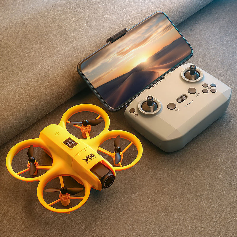 Mini yellow quadcopter drone with controller and smartphone mount
