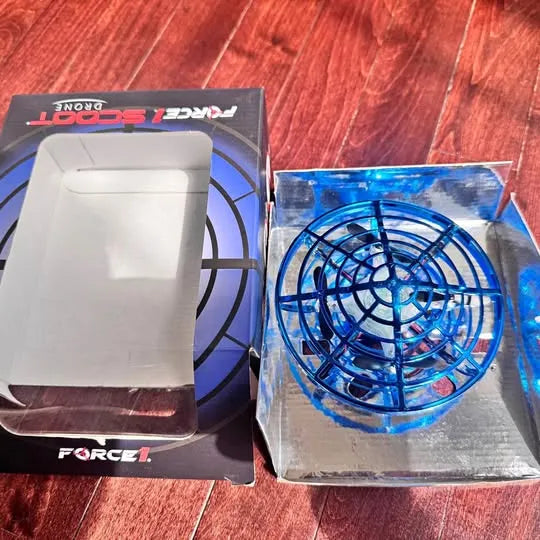 Kids hand-gesture drone with blue circular prop guard, shown in retail packaging