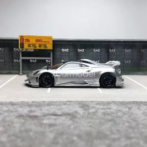 Silver diecast model car with side profile view and black wheels