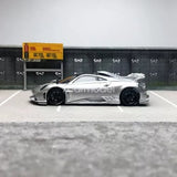 Silver diecast model car with side profile view and black wheels