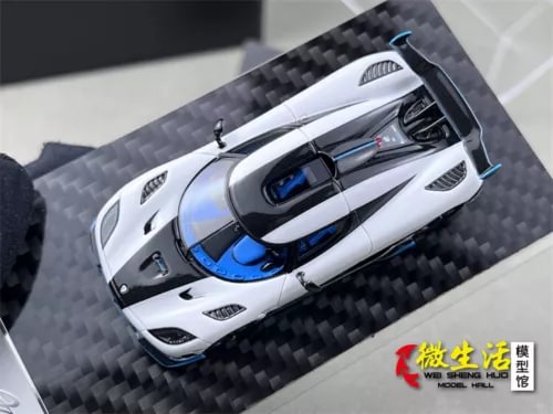 White sports diecast car model with blue accents, front 3/4 view