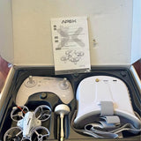 Drone kit with white controller, compact quadcopter, and VR70 user manual