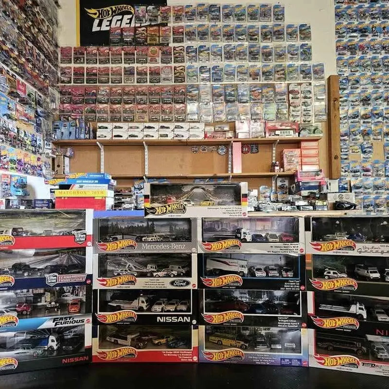 Hot Wheels diecast car collection display with boxed cars, multiple models