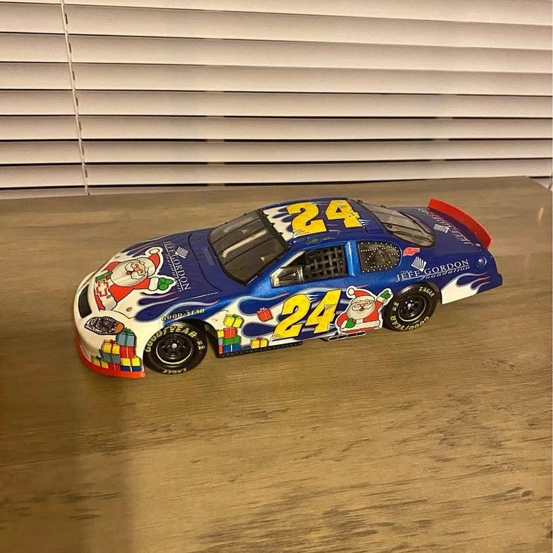 Diecast race car model in blue with red accents and large #24 graphic