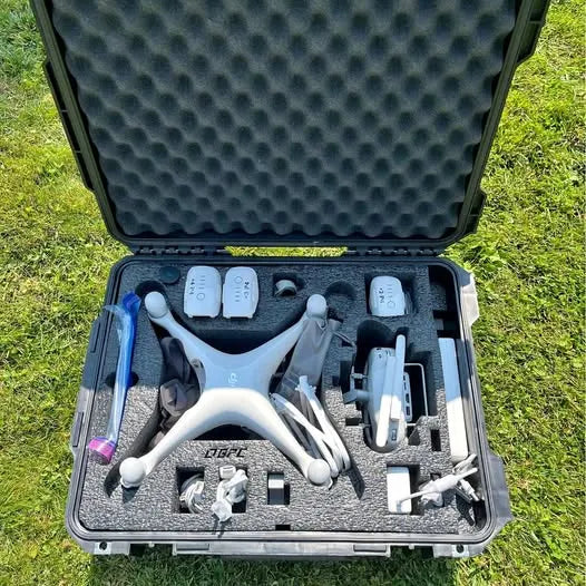 Hard case with foam insert holding white DJI Phantom 4 drone and accessories