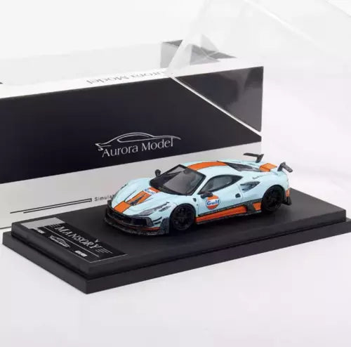 Diecast model car with orange and blue Gulf-style racing livery on display base