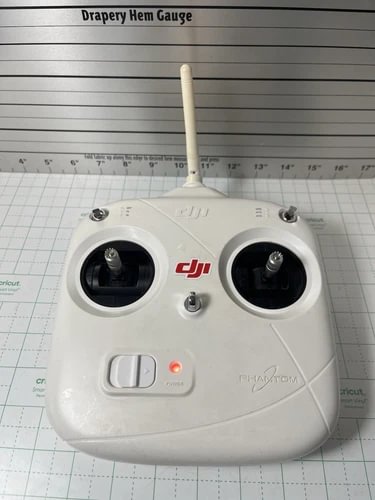 DJI Phantom drone controller remote with dual joysticks and front buttons, white case
