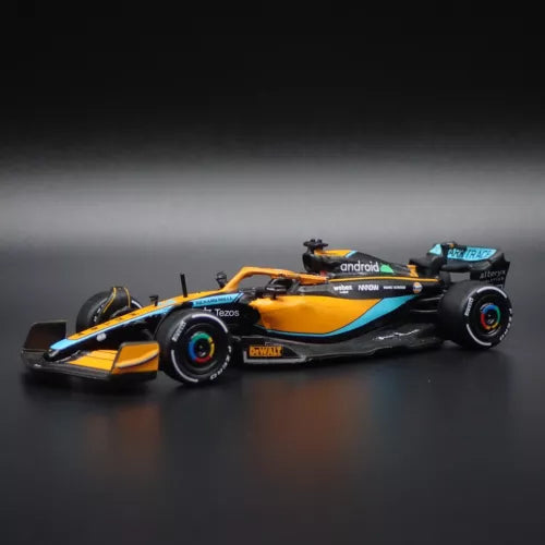 Orange and black diecast Formula racing car model, front three-quarter view.