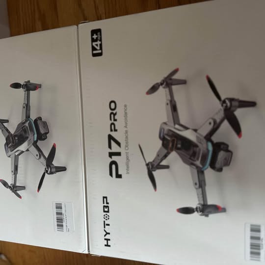 F117 PRO drone shown in retail box, four propellers on a gray body