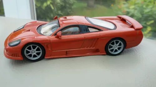 Metallic copper 1:43 scale diecast supercar, side view, detailed wheels