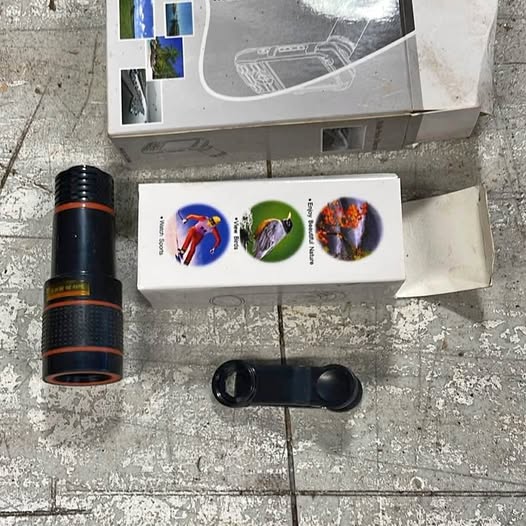 Mobile phone telescope with orange-striped barrel and black lens adapter